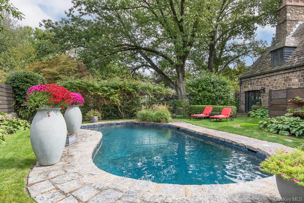 21 Hampshire Road Bronxville, NY 10708 - Photo 2 of 41 Nestled on nearly an acre of perfectly landscaped property with a newly refinished swimming pool, a beautiful wrap-around stone terrace, and several stone patios create a seamless indoor-outdoor lifestyle thoughtfully designed around the enchanting and private setting.