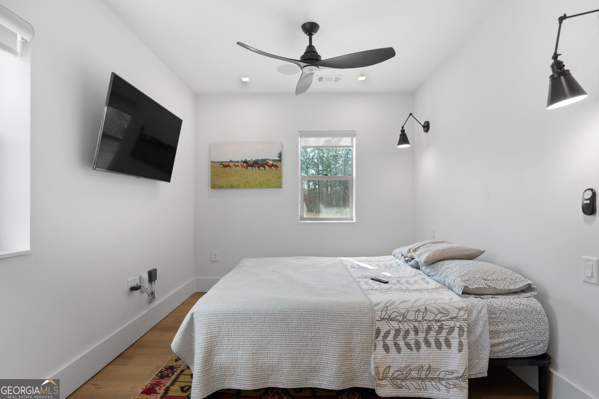 1140 City Pond Road Barnesville, GA 30204 - Photo 15 of 37 a bedroom with a bed a flat screen tv and a window