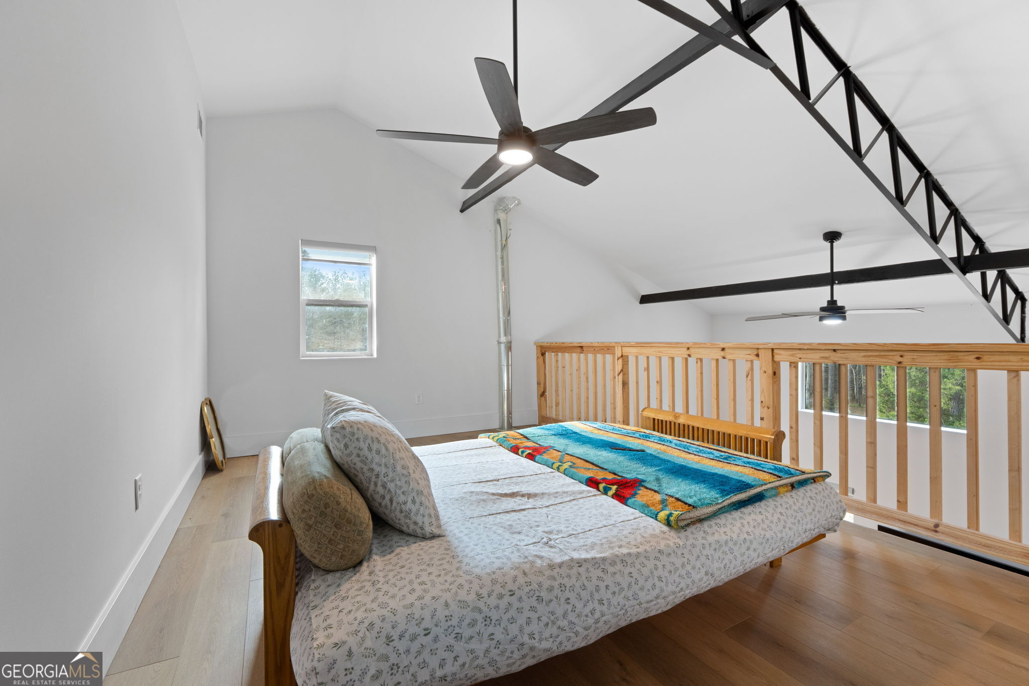 1140 City Pond Road Barnesville, GA 30204 - Photo 21 of 37 a bed sitting in a bedroom next to a window