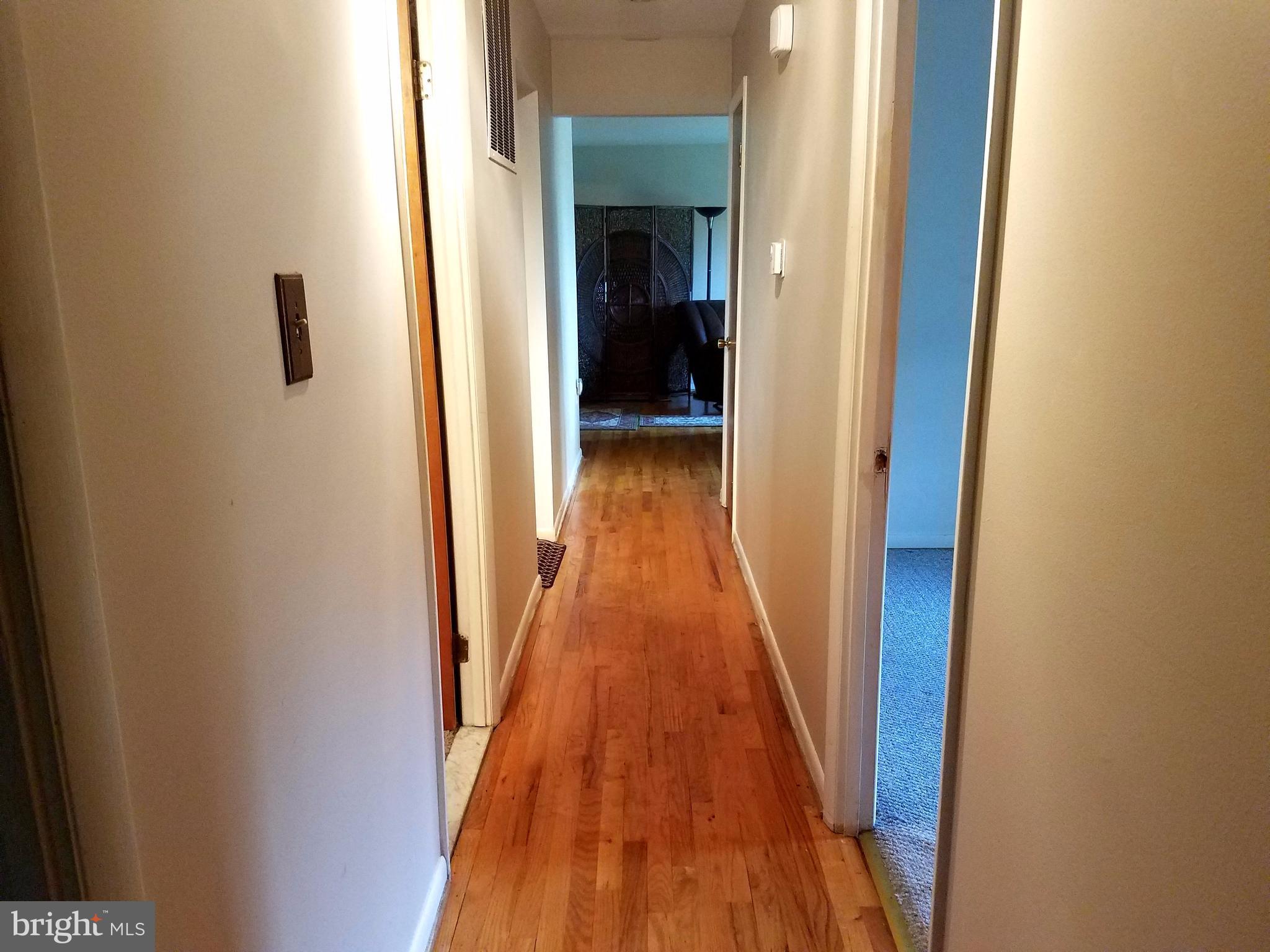 6901 Friendship Road Clinton, MD 20735 - Photo 11 of 26 a view of a hallway with wooden floor and staircase