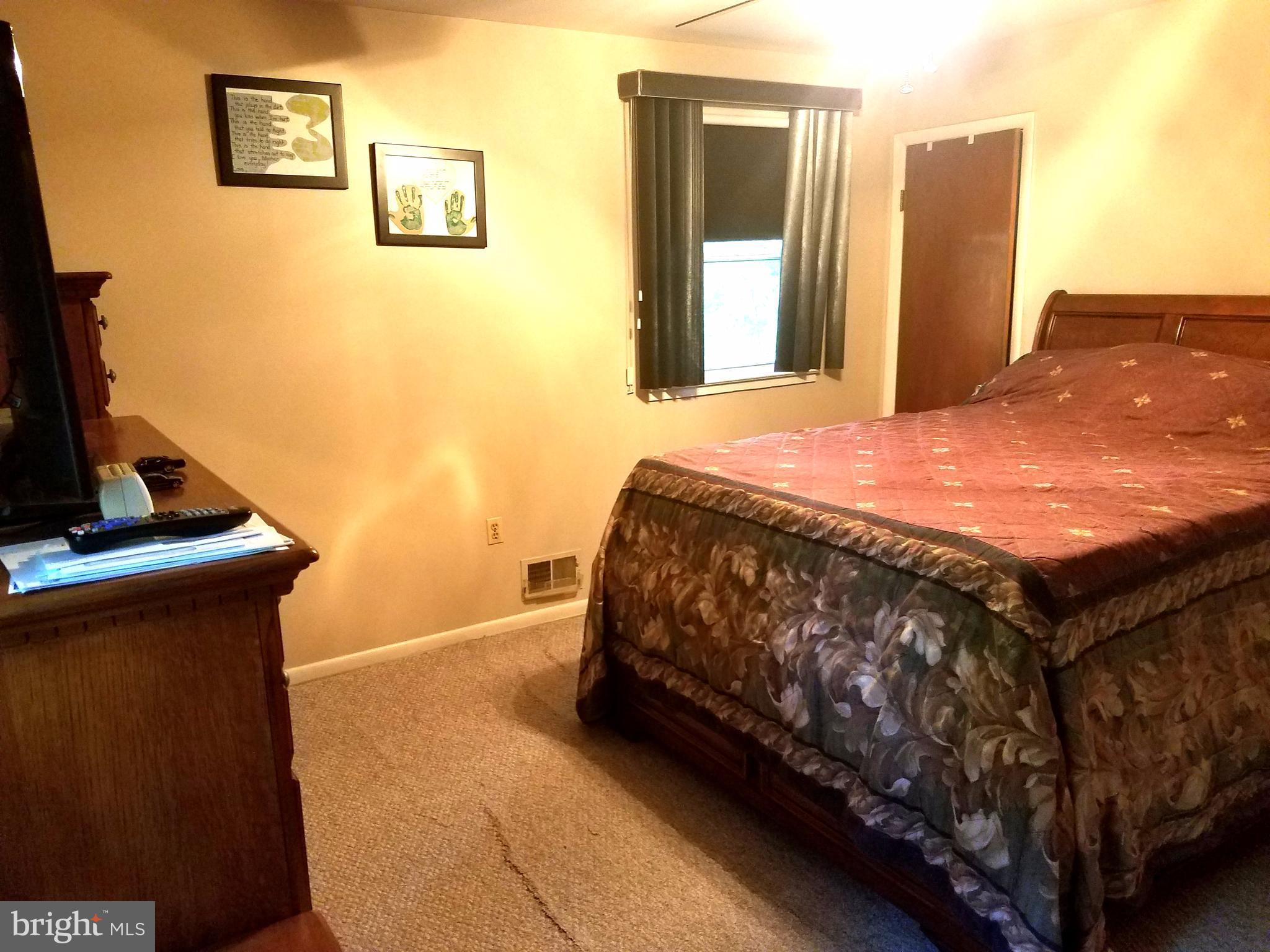 6901 Friendship Road Clinton, MD 20735 - Photo 14 of 26 a bedroom with a bed and a flat screen tv