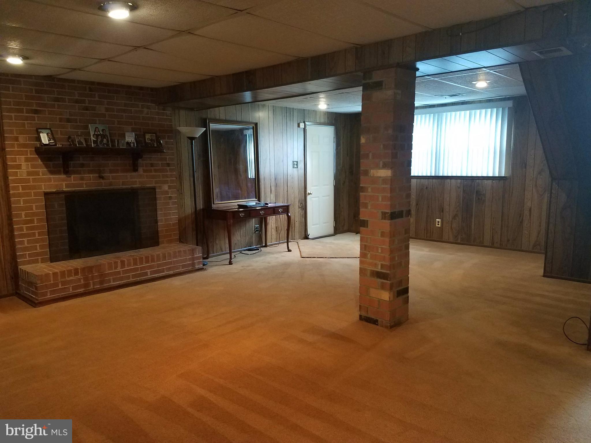 6901 Friendship Road Clinton, MD 20735 - Photo 16 of 26 a view of empty room with wooden floor and fireplace
