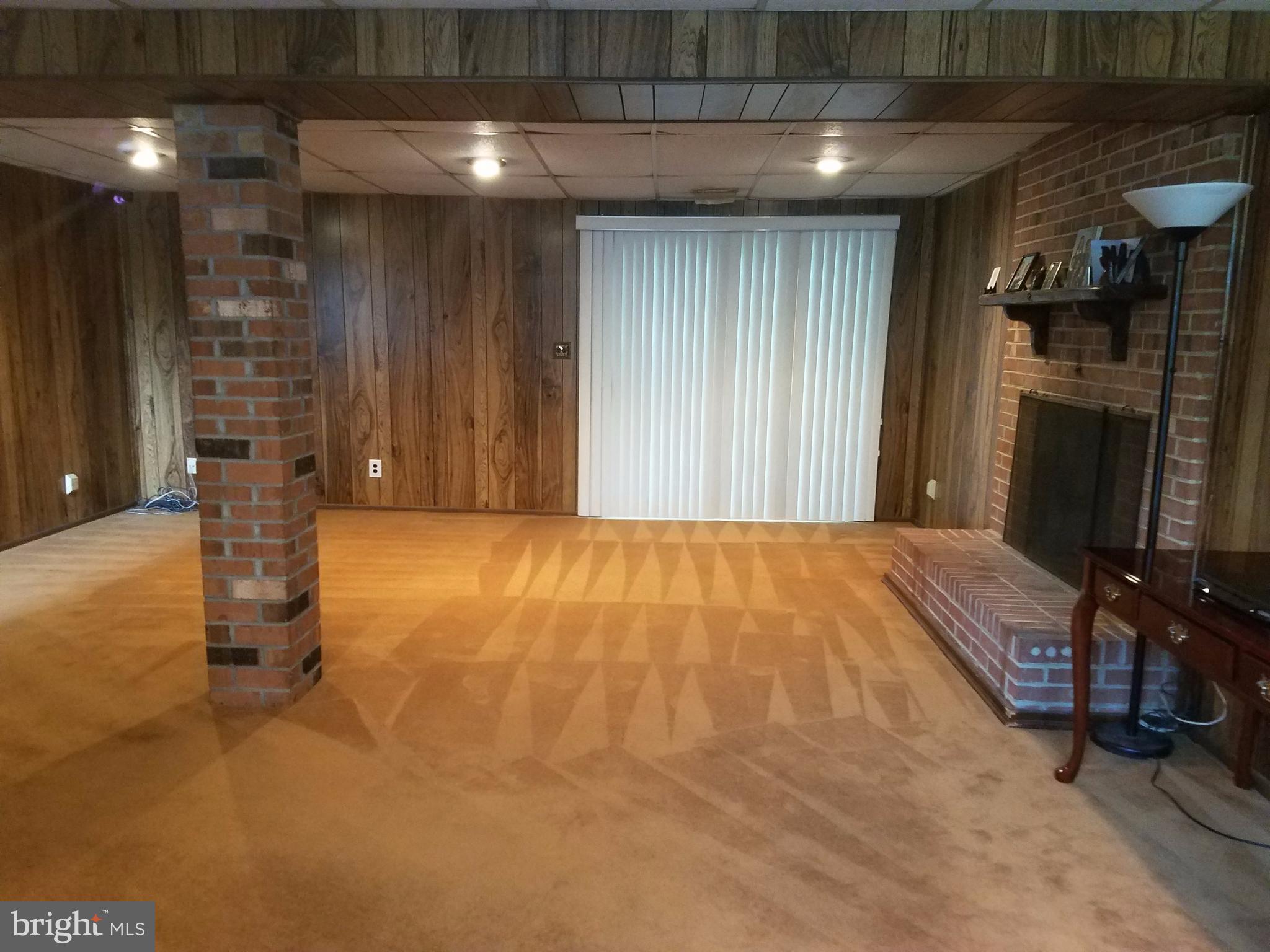 6901 Friendship Road Clinton, MD 20735 - Photo 17 of 26 a bedroom with a bed and a fireplace
