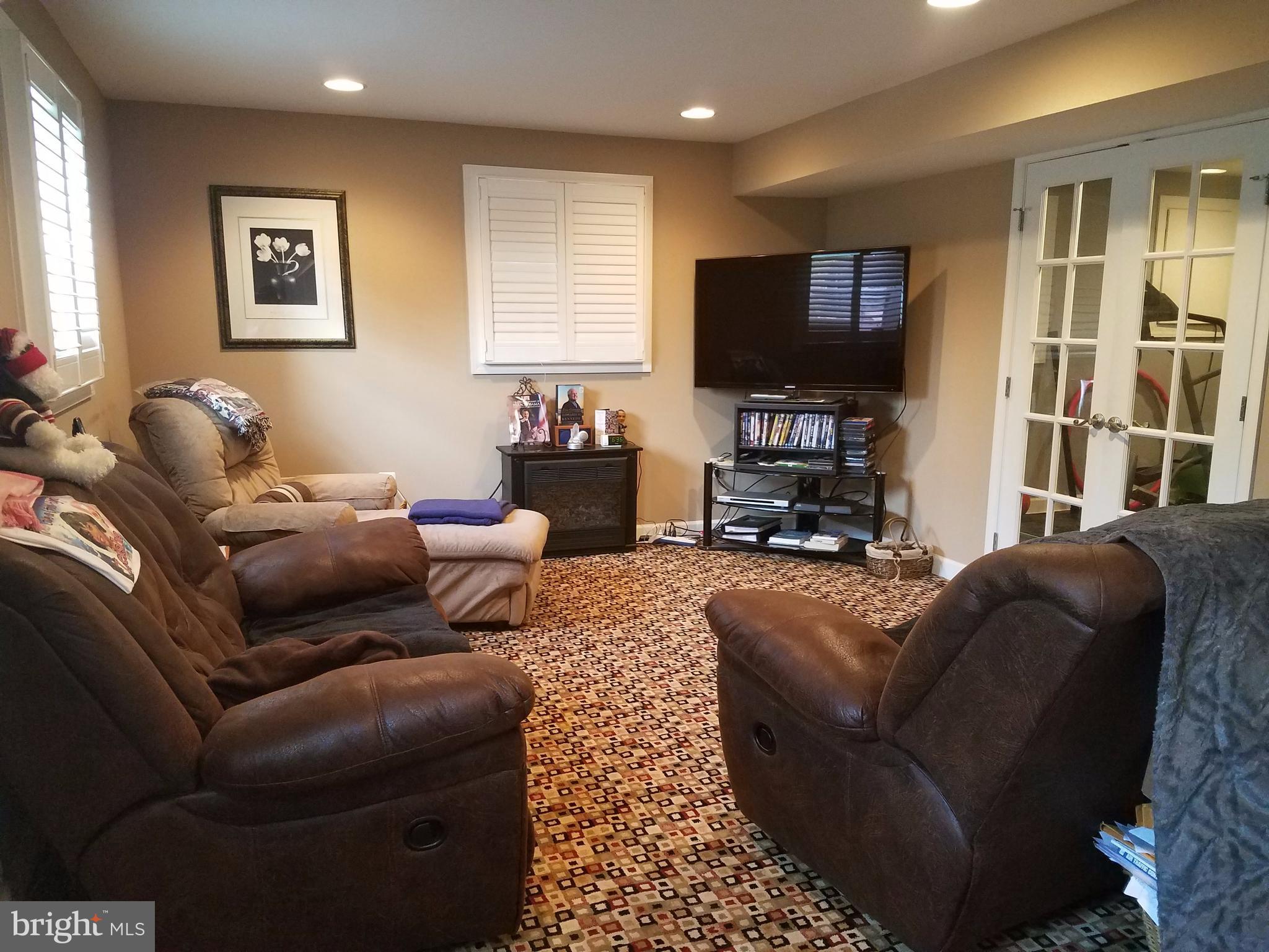 6901 Friendship Road Clinton, MD 20735 - Photo 21 of 26 a living room with furniture a flat screen tv and a window
