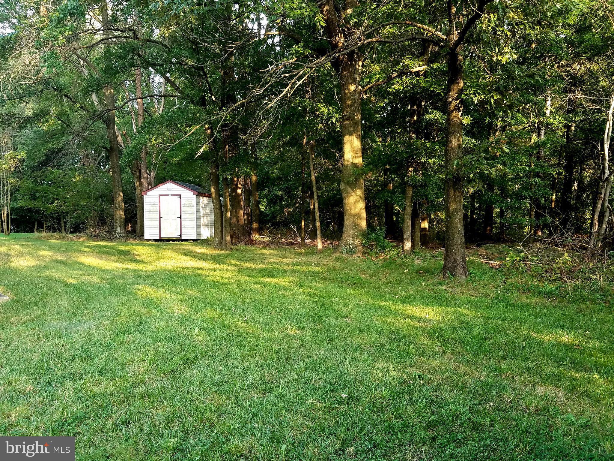 6901 Friendship Road Clinton, MD 20735 - Photo 24 of 26 a view of a house with a big yard and large trees