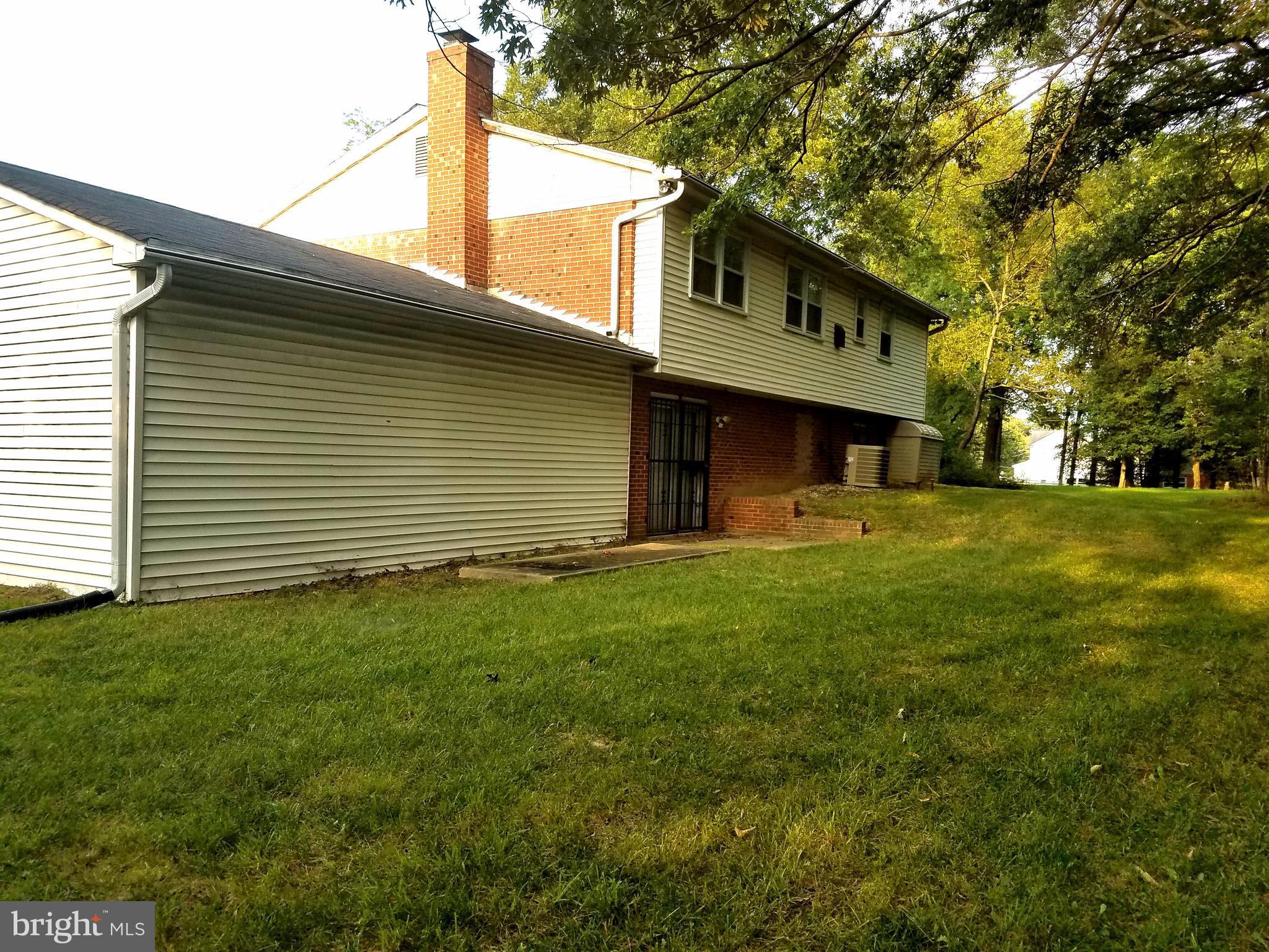 6901 Friendship Road Clinton, MD 20735 - Photo 25 of 26 a front view of a house with a garden