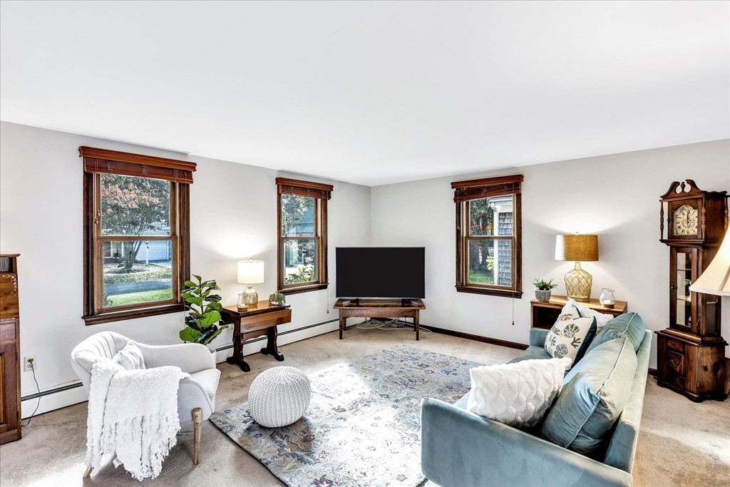 56 Danas Path Yarmouth, MA 02673 - Photo 11 of 32 a living room with furniture and a flat screen tv