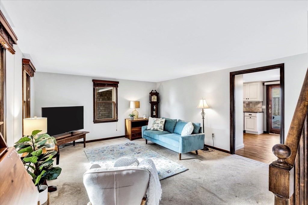 56 Danas Path Yarmouth, MA 02673 - Photo 12 of 32 a living room with furniture and a flat screen tv