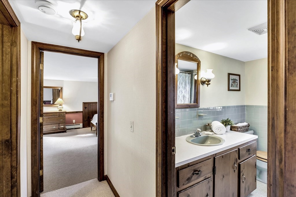 56 Danas Path Yarmouth, MA 02673 - Photo 24 of 32 a en suite bathroom with a sink and a mirror