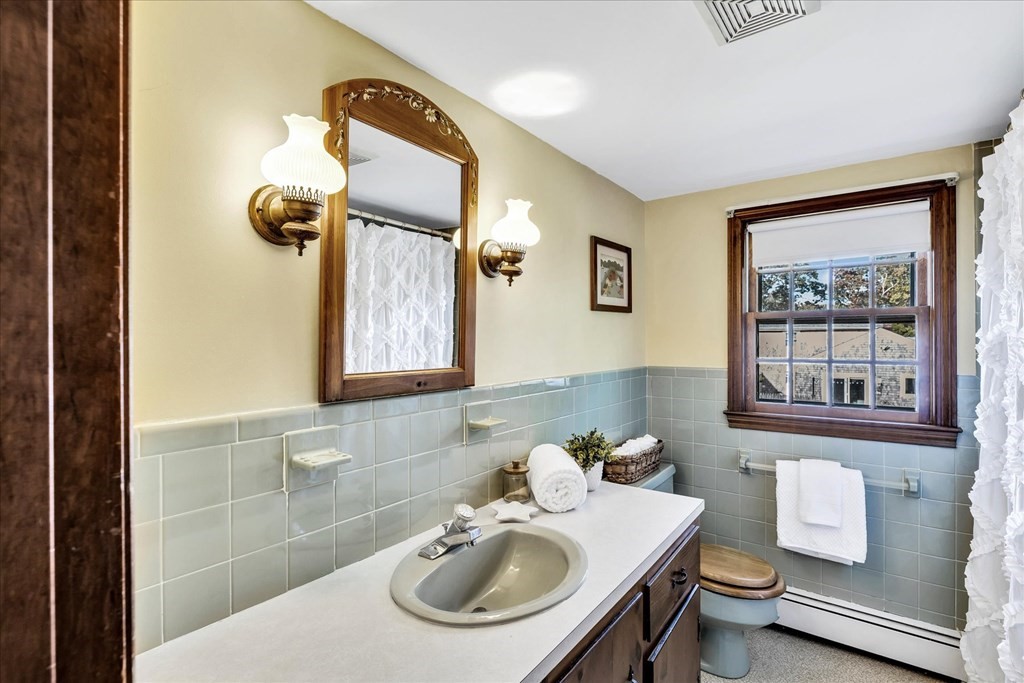 56 Danas Path Yarmouth, MA 02673 - Photo 25 of 32 a bathroom with a sink mirror and toilet