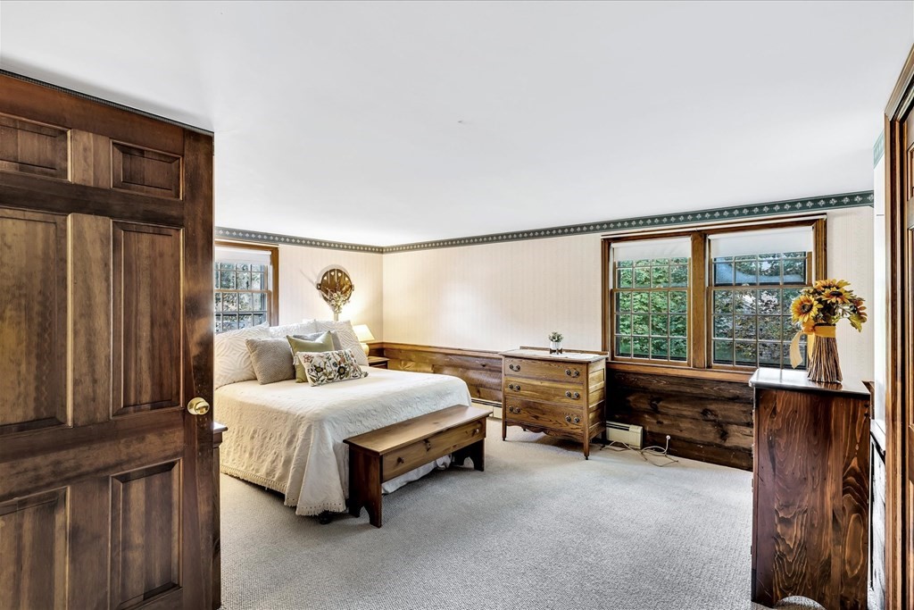 56 Danas Path Yarmouth, MA 02673 - Photo 26 of 32 a bedroom with a bed and large windows