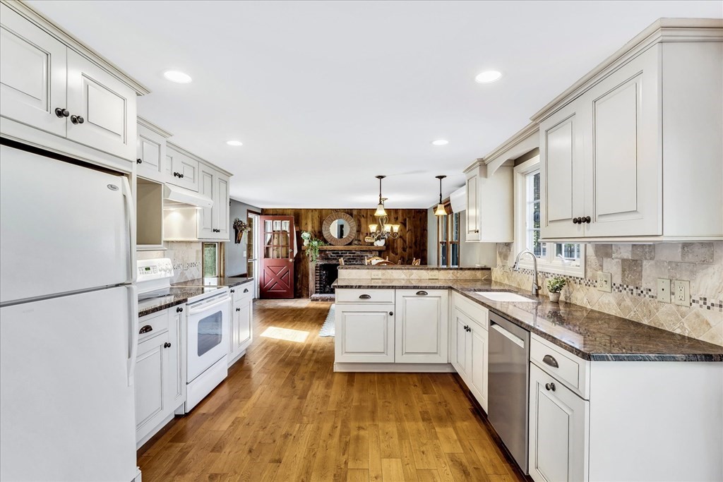 56 Danas Path Yarmouth, MA 02673 - Photo 9 of 32 a kitchen with granite countertop a sink stainless steel appliances and cabinets