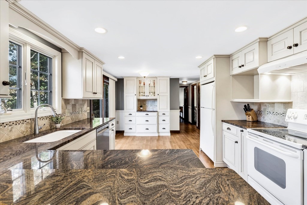 56 Danas Path Yarmouth, MA 02673 - Photo 10 of 32 a large kitchen with stainless steel appliances kitchen island granite countertop a lot of counter space and a sink