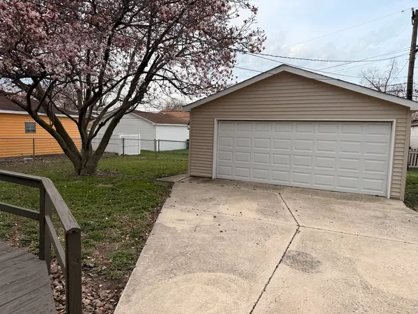 a view of backyard of house and trees
