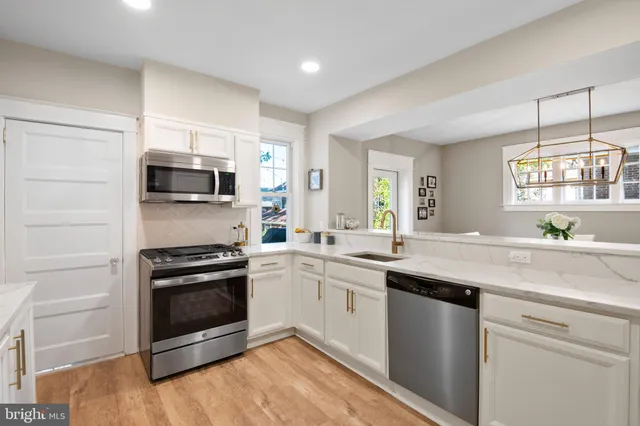 a kitchen with a sink stove and microwave
