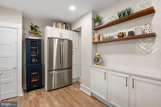 a kitchen with stainless steel appliances granite countertop a refrigerator and a stove