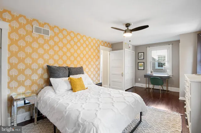 a bedroom with a bed a table and chair