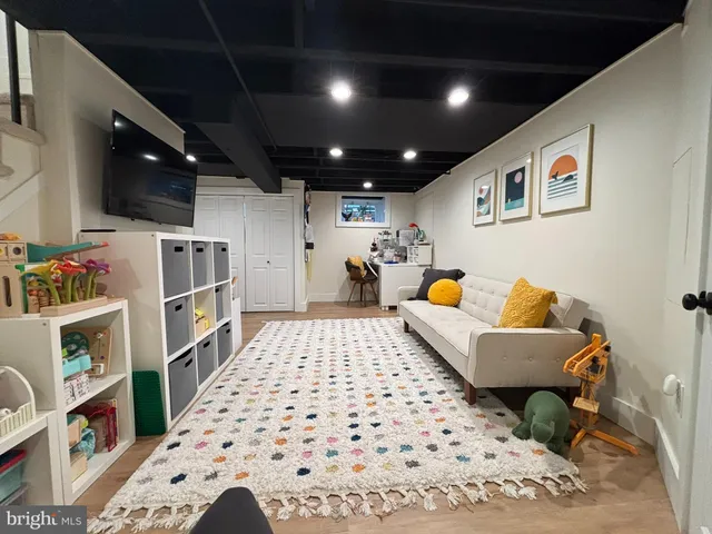 a living room with a couch and a bookshelf