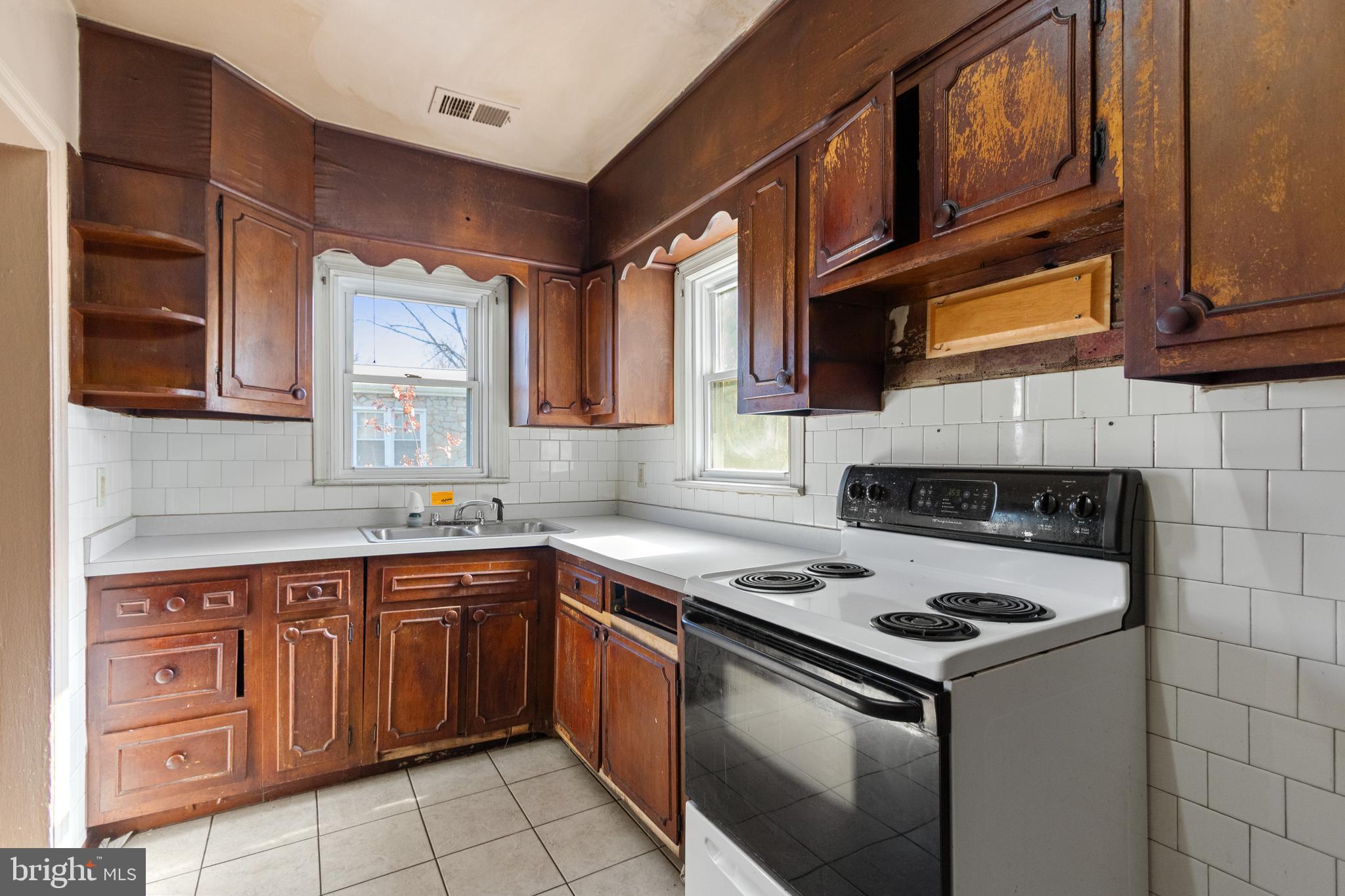 6009 Old Silver Hill Road District Heights, MD 20747 - Photo 11 of 24 a kitchen with stainless steel appliances granite countertop a sink stove and cabinets