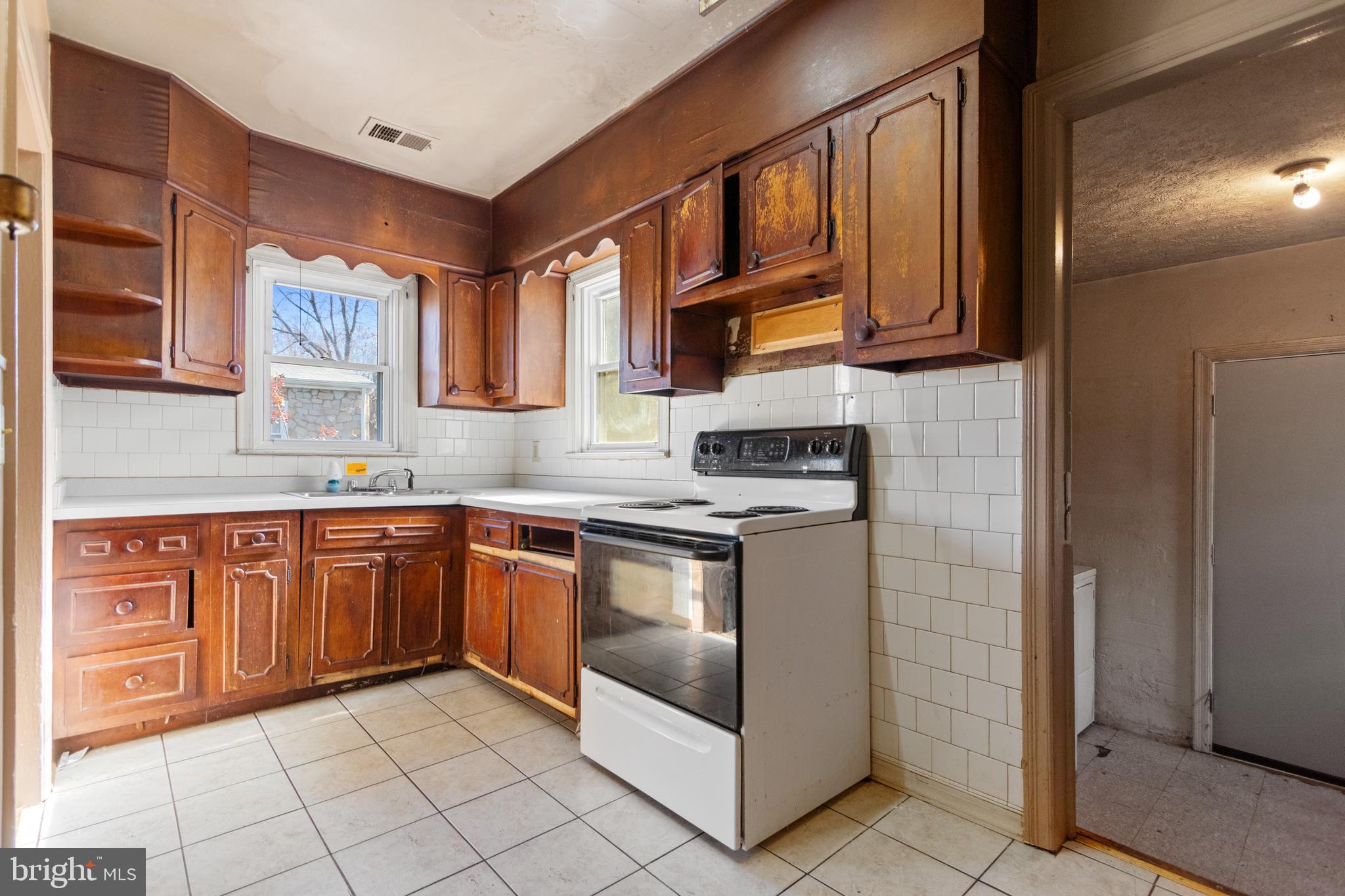 6009 Old Silver Hill Road District Heights, MD 20747 - Photo 12 of 24 a kitchen with stainless steel appliances granite countertop a stove sink and cabinets