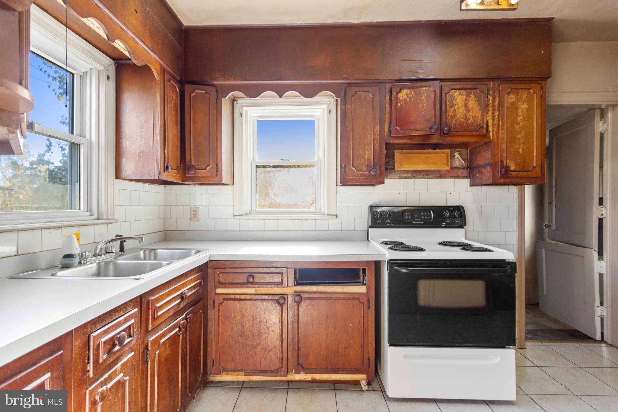 6009 Old Silver Hill Road District Heights, MD 20747 - Photo 10 of 24 a kitchen with a sink stove and refrigerator