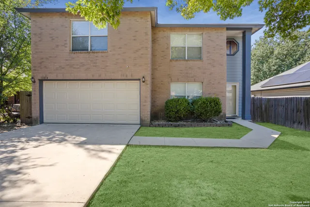a front view of a house with a yard and garage
