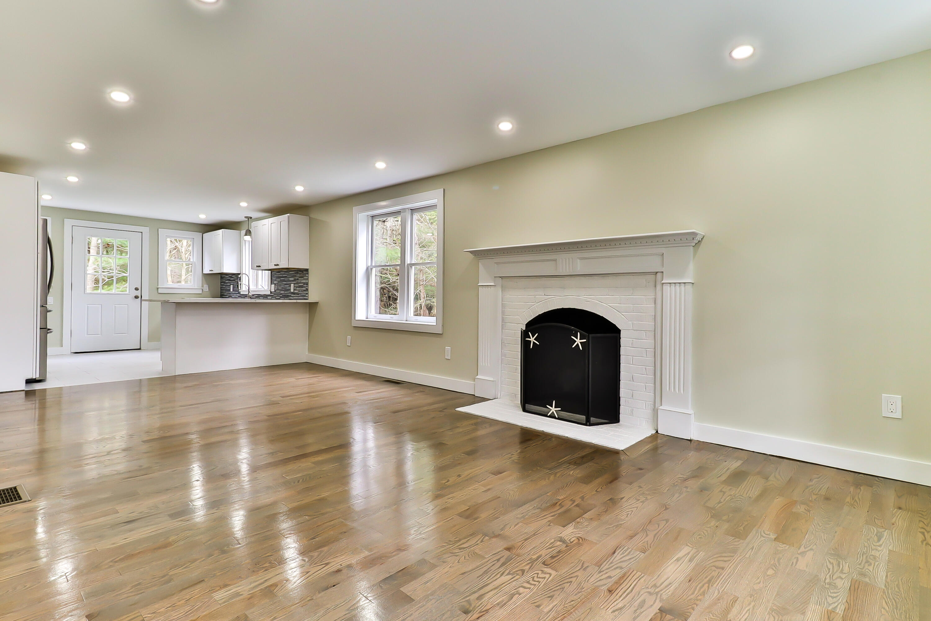 40 Richardson Road Centerville, MA 02632 - Photo 6 of 35 a view of a livingroom with a fireplace window and wooden floor