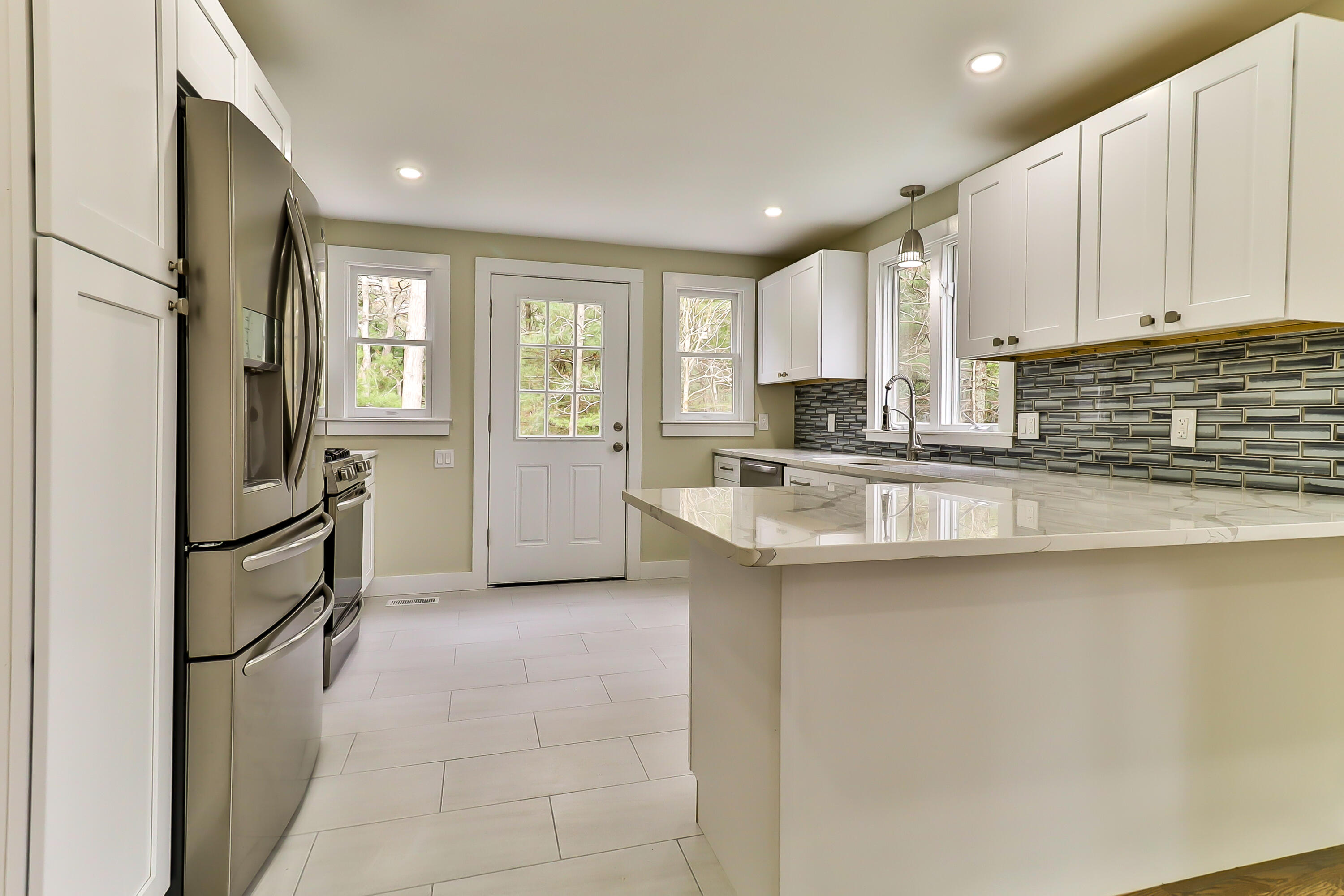 40 Richardson Road Centerville, MA 02632 - Photo 10 of 35 a kitchen with stainless steel appliances granite countertop a stove a sink and a refrigerator