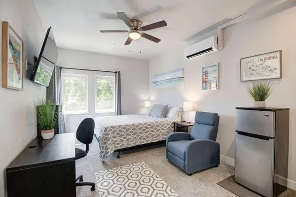 a bedroom with furniture and a window