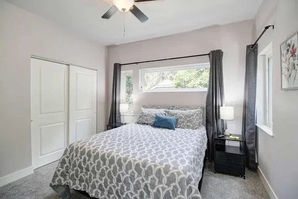 a bedroom with a bed and a window