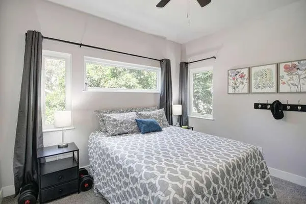 a bedroom with a large bed and a window