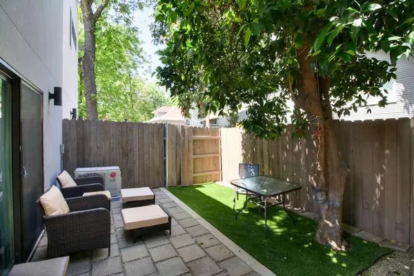 a backyard of a house with table and chairs