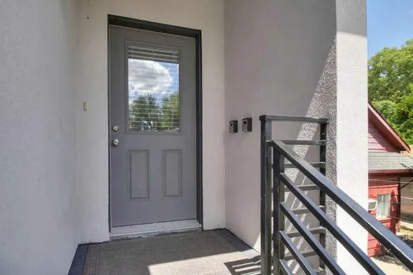 a view of entryway with wooden floor and stairs