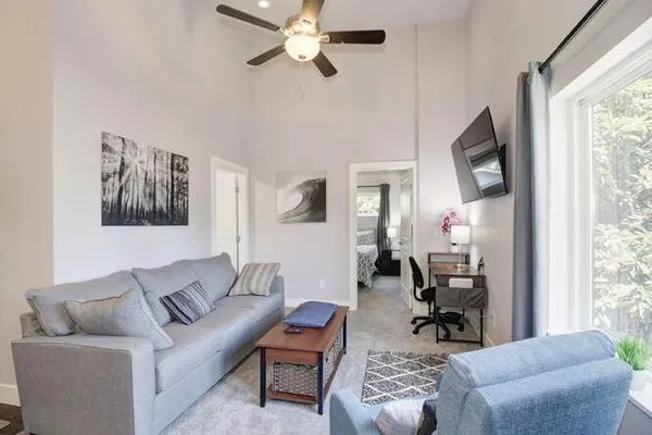 a living room with furniture a rug and a window