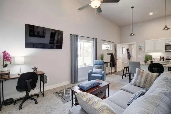 a living room with furniture and a flat screen tv
