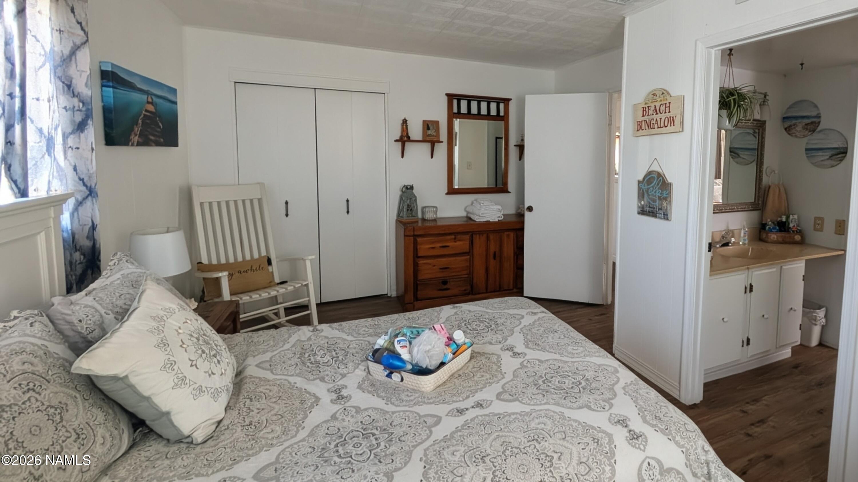 15702 Bonanza Loop Ehrenberg, AZ 85334 - Photo 9 of 13 a bedroom with furniture and a wooden floor