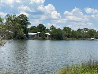 240 Buck Road Santa Rosa Beach, FL 32459 - Photo 14 of 17 a view of lake with boats and trees in the background