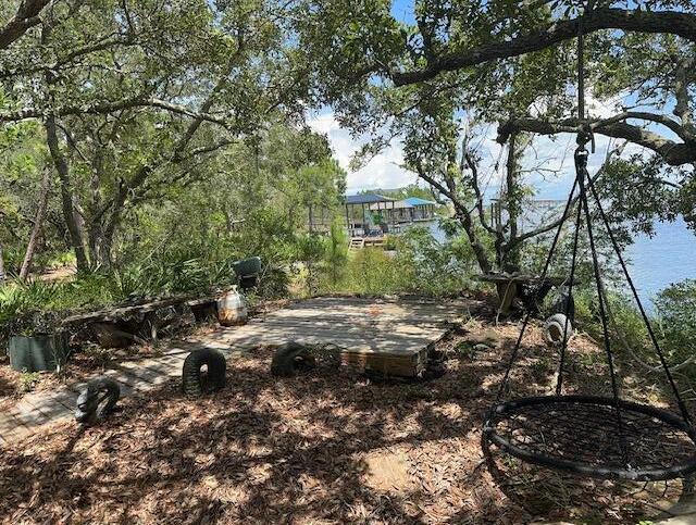 240 Buck Road Santa Rosa Beach, FL 32459 - Photo 17 of 17 a view of lot of trees and car parked
