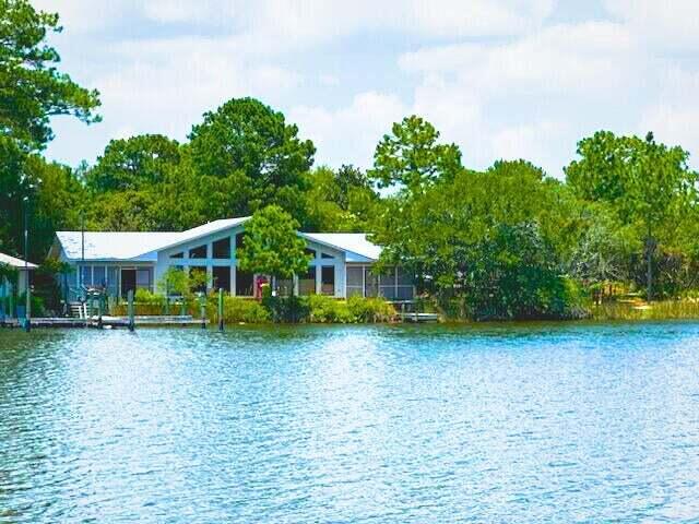 240 Buck Road Santa Rosa Beach, FL 32459 - Photo 2 of 17 a view of a house with a yard