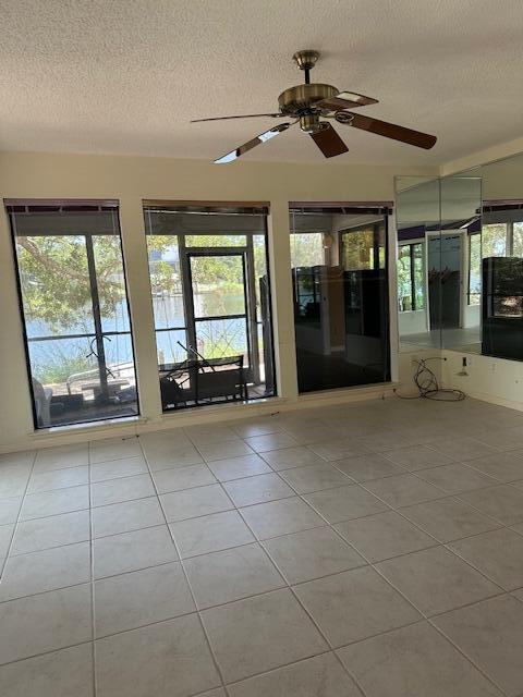 240 Buck Road Santa Rosa Beach, FL 32459 - Photo 9 of 17 an empty room with chandelier fan and windows