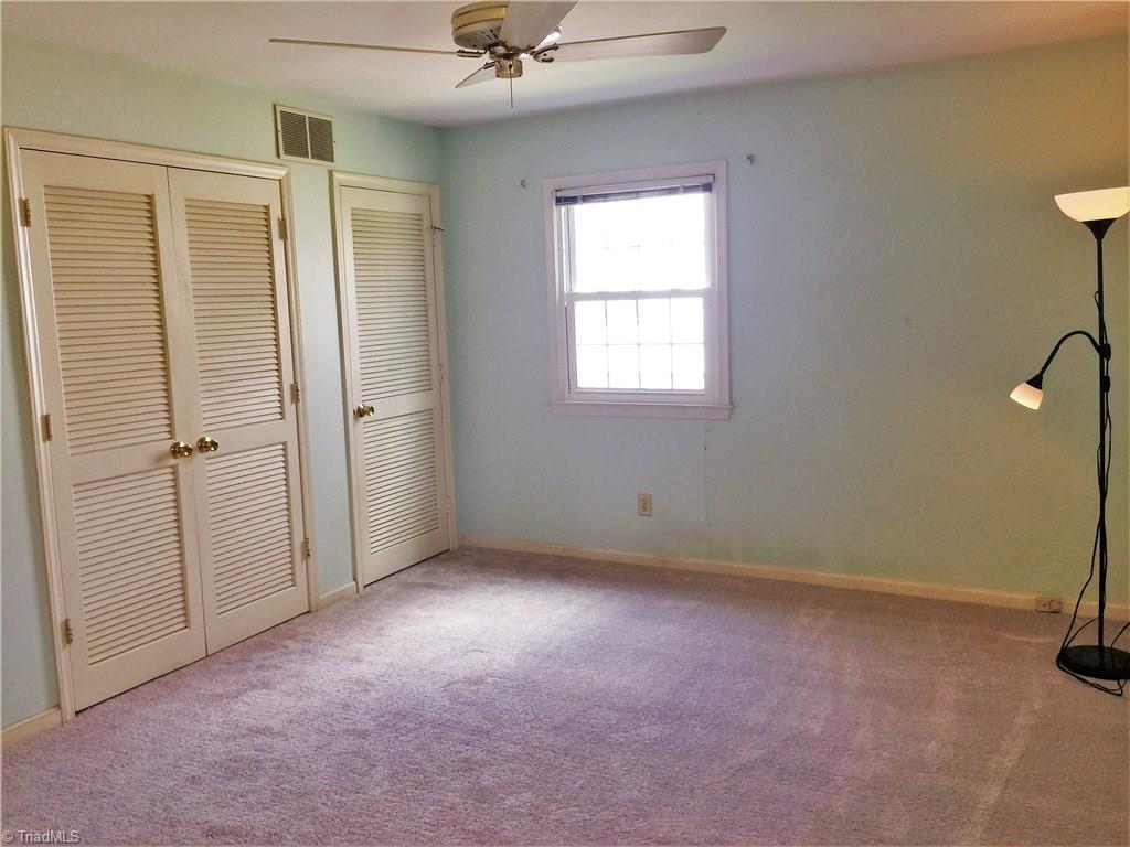 2102 Red Forest Road Greensboro, NC 27410 - Photo 11 of 24 Master bedroom with two closets and ensuite bathroom and new carpet