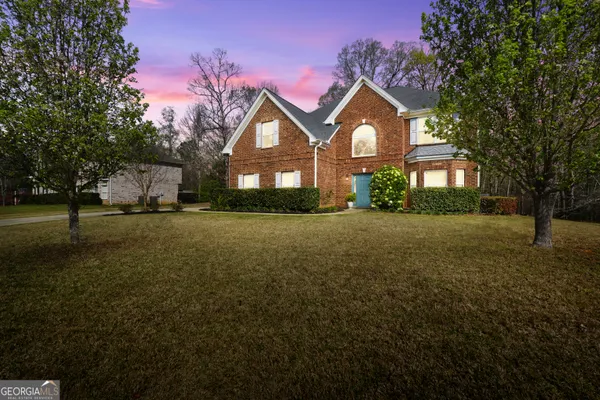a front view of a house with a yard and garage