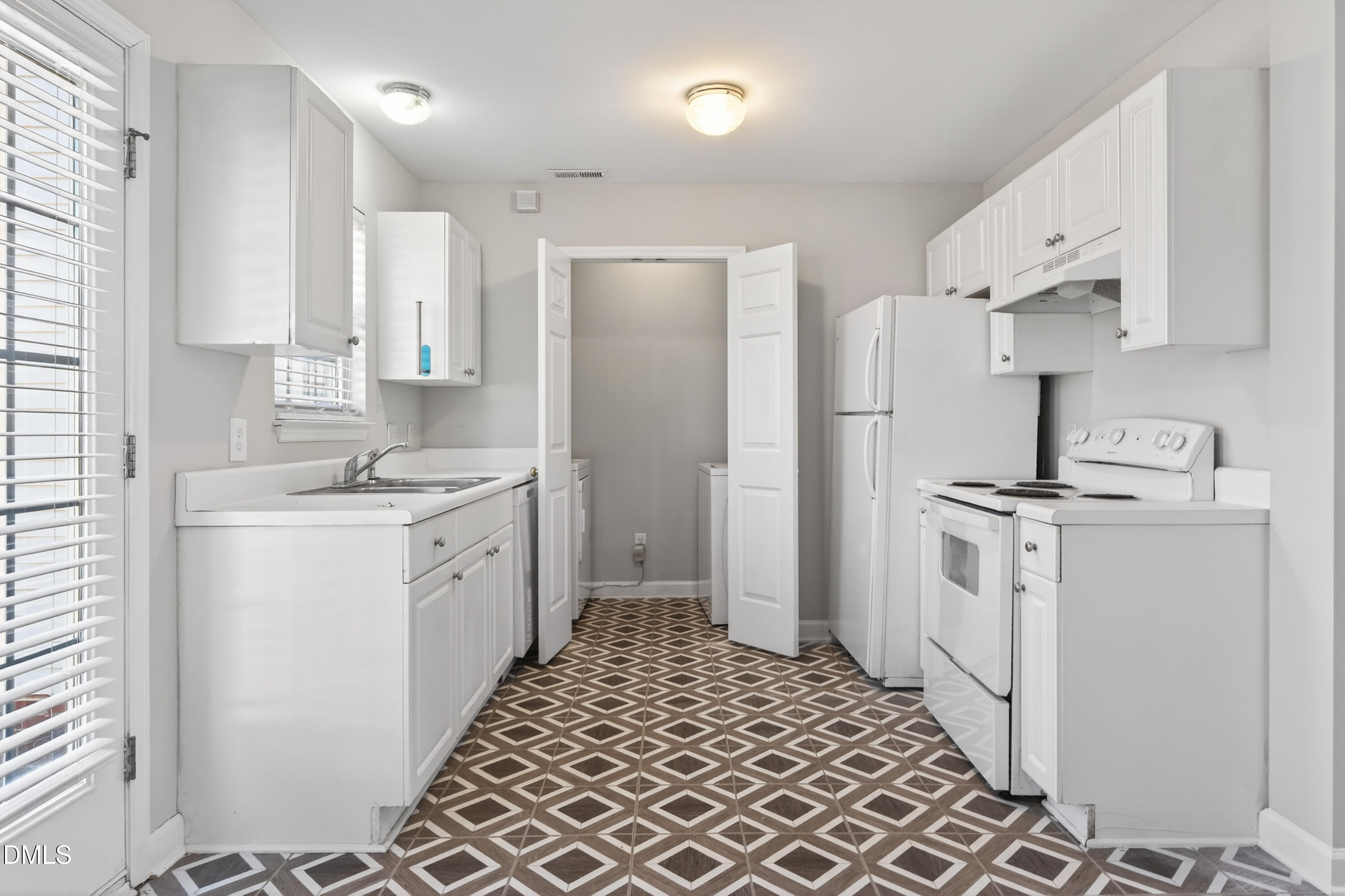 1601 Briarmont Court Raleigh, NC 27610 - Photo 12 of 30 a large white kitchen with a sink stainless steel appliances and cabinets