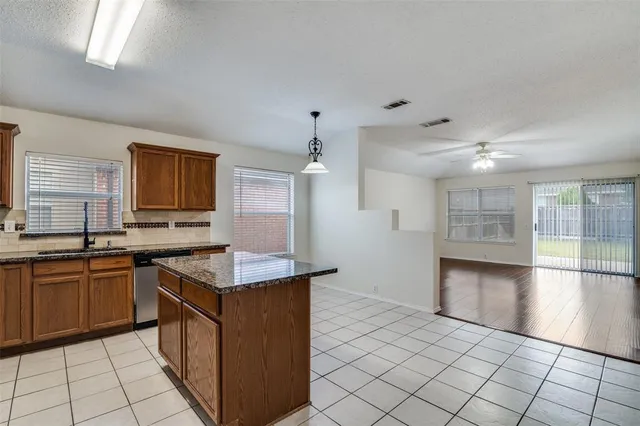 a kitchen with stainless steel appliances granite countertop a sink and a stove