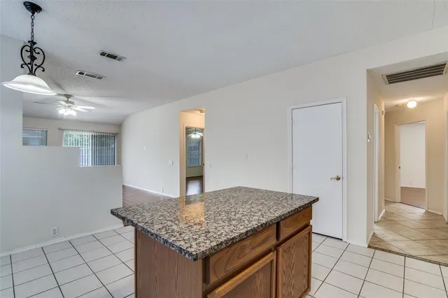a kitchen with kitchen island a counter top space and cabinets