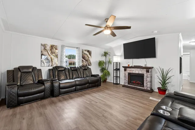 a living room with furniture a fireplace and a flat screen tv