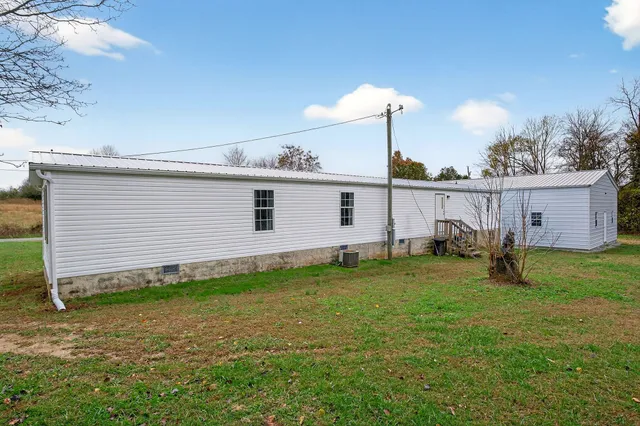 a view of a backyard with plants and a barbeque