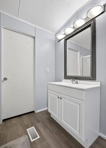 a bathroom with a double vanity sink and mirror