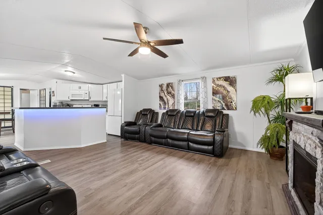 a living room with furniture and a wooden floor