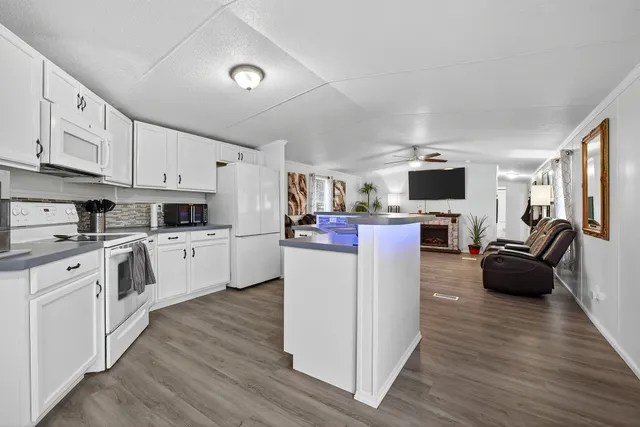 a kitchen with cabinets and wooden floor